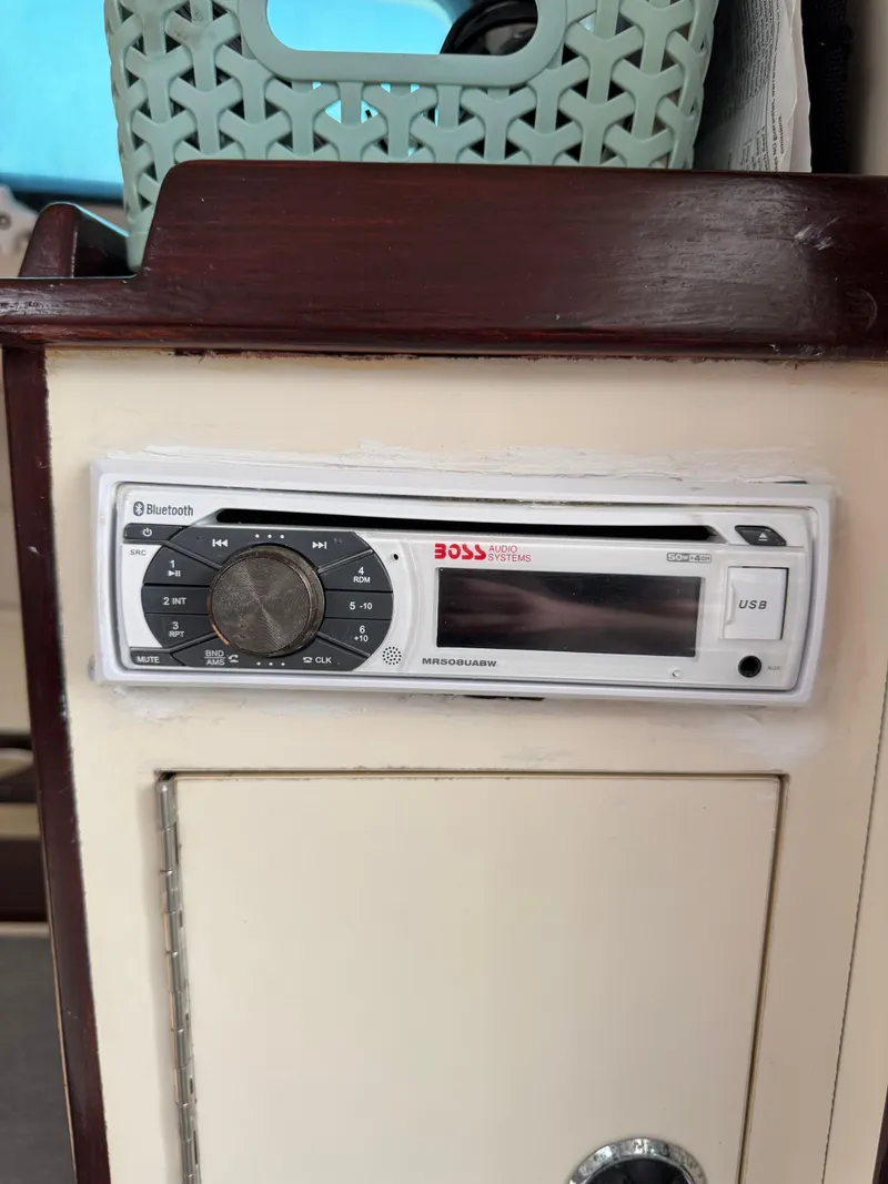 Slide: The Image of Boat interior with Boss audio system, Albin Tournament Express 1996, featuring Bluetooth and USB connectivity. - 28