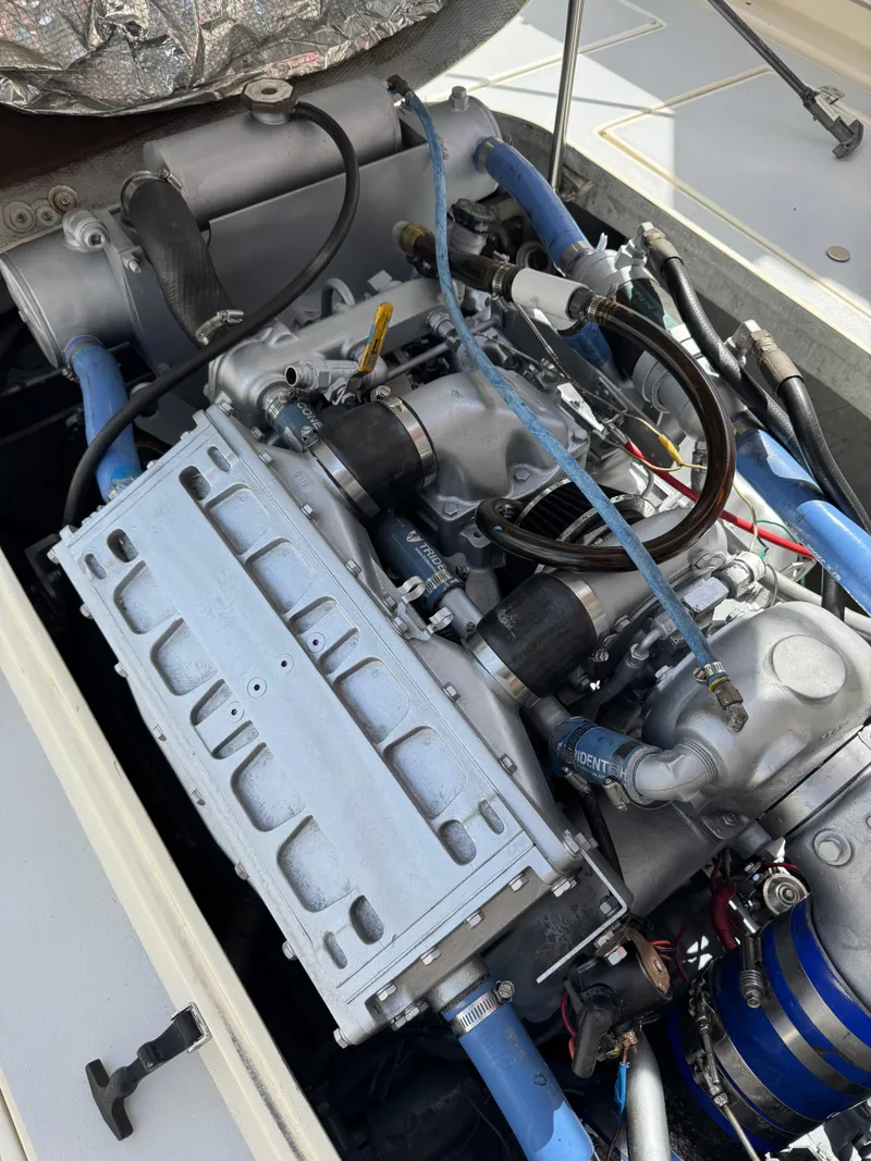 Slide: The Image of Engine of a 1996 Albin Tournament Express boat with visible components and hoses. - 34