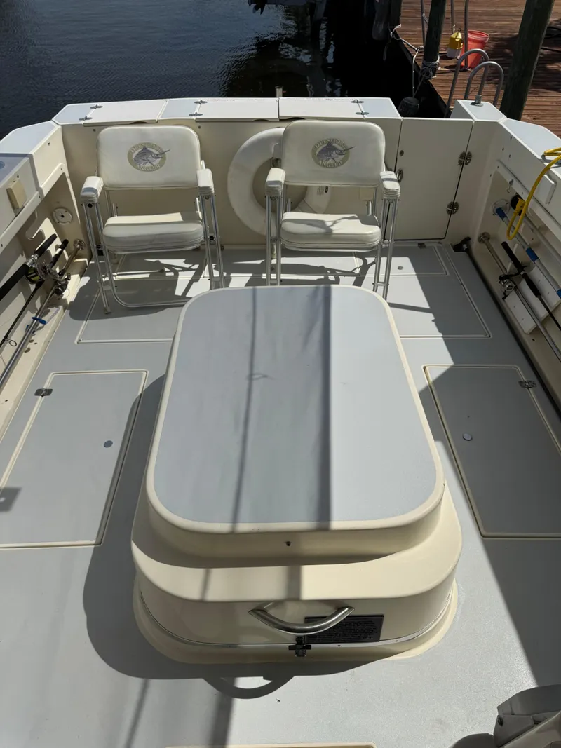 Slide: The Image of 1996 Albin Tournament Express boat deck with chairs and storage compartment. - 5