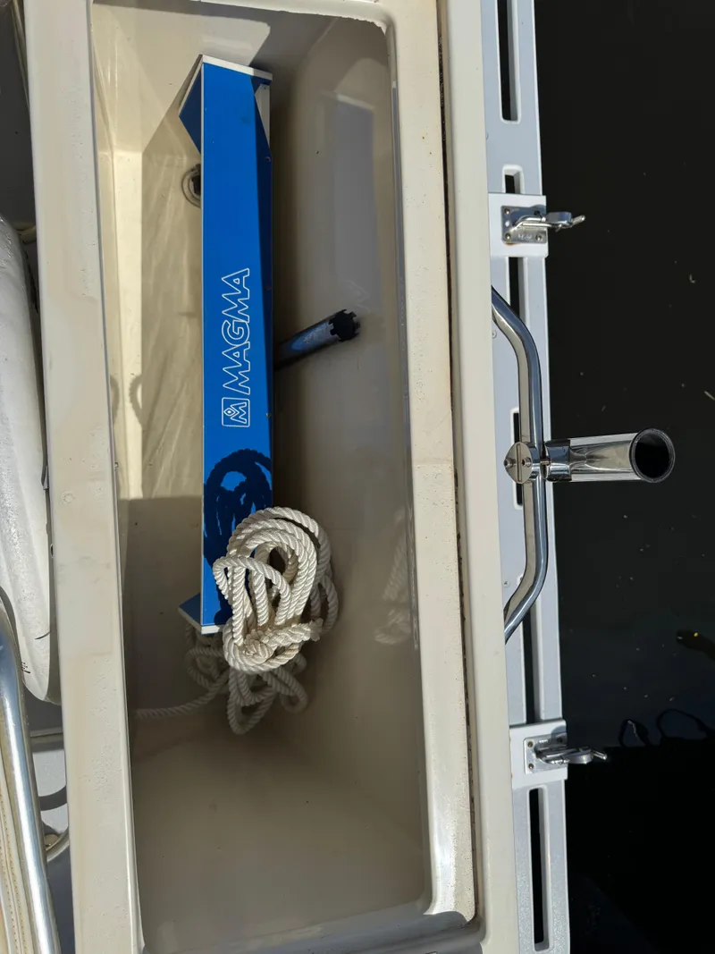 Slide: The Image of Storage compartment on 1996 Albin Tournament Express boat with rope and Magma accessory. - 8