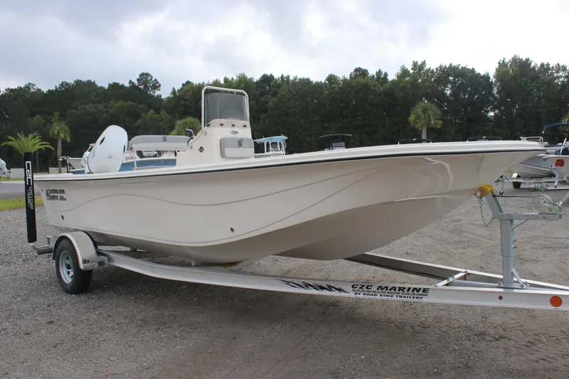 Slide: The Image of 2024 Carolina Skiff 21 LS boat on trailer, parked outdoors. - 0