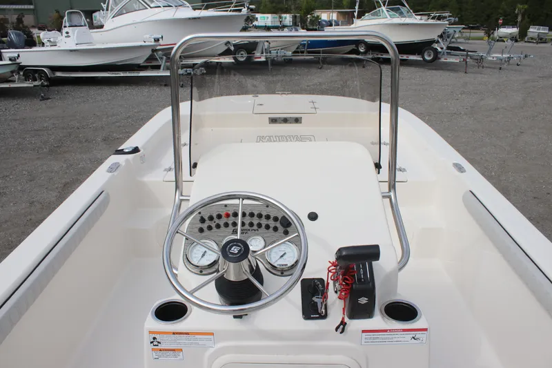 Slide: The Image of 2024 Carolina Skiff 21 LS boat dashboard with steering wheel and controls. - 17