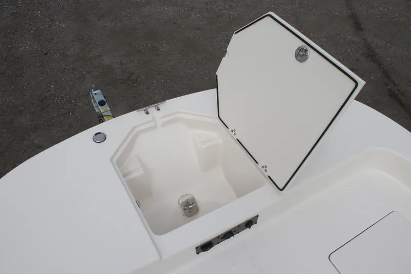 Slide: The Image of 2024 Carolina Skiff 21 LS boat storage compartment with open hatch. - 22