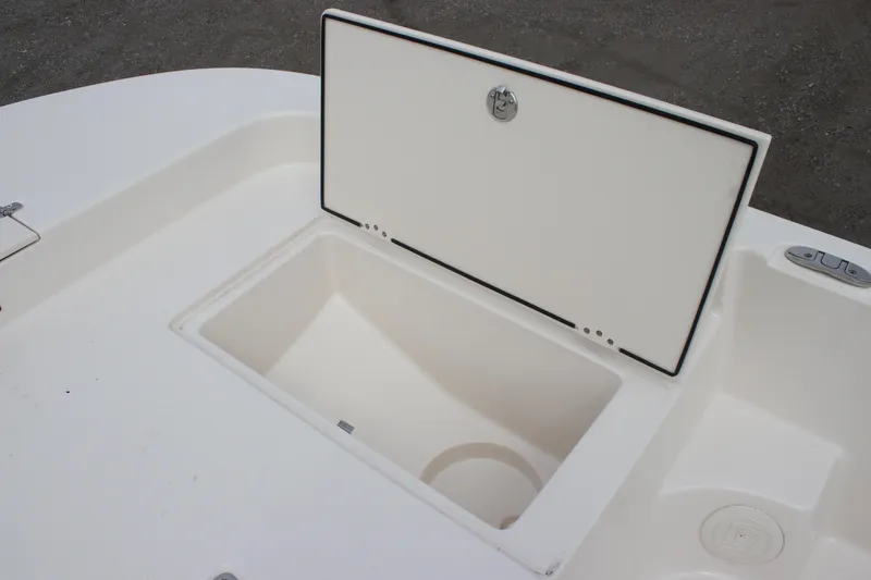 Slide: The Image of 2024 Carolina Skiff 21 LS boat storage compartment open on deck. - 23