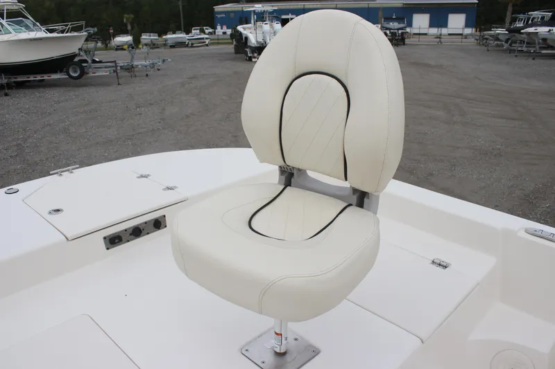 Slide: The Image of 2024 Carolina Skiff 21 LS boat seat, white upholstery, outdoor setting. - 26