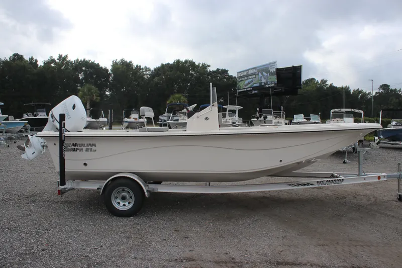 Slide: The Image of 2024 Carolina Skiff 21 LS boat on trailer, parked outdoors. - 3