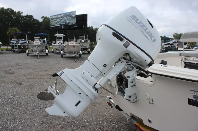 Slide: The Image of 2024 Carolina Skiff 21 LS with Suzuki outboard motor in a boat dealership lot. - 9