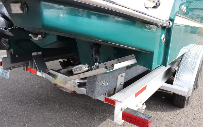 Slide: The Image of 2022 Ranger Tugs R-25 boat on trailer, rear view showing hull and trailer details. - 10