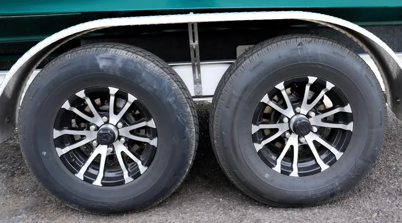 Slide: The Image of Dual wheels of a 2022 Ranger Tugs R-25 trailer on asphalt. - 12