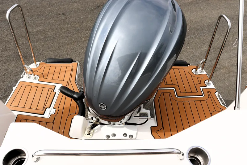 Slide: The Image of 2022 Ranger Tugs R-25 boat with outboard motor and teak deck. - 14