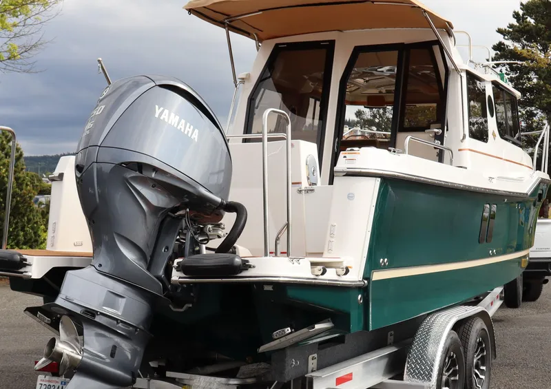 Slide: The Image of 2022 Ranger Tugs R-25 boat with Yamaha outboard motor on a trailer. - 2