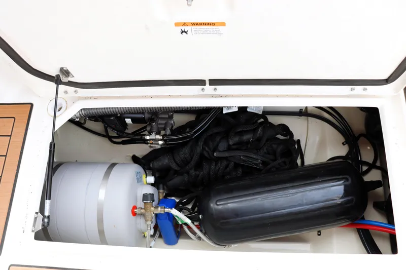 Slide: The Image of 2022 Ranger Tugs R-25 engine compartment with visible components and wiring. - 20