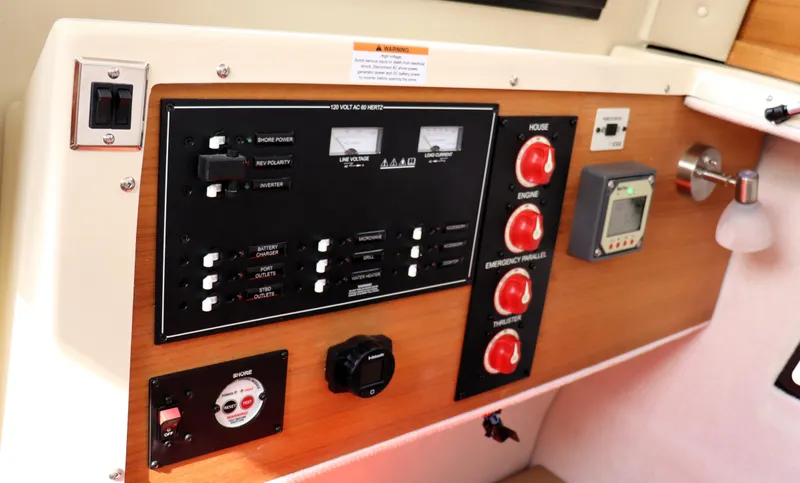 Slide: The Image of Control panel of 2022 Ranger Tugs R-25 boat with switches and gauges. - 25
