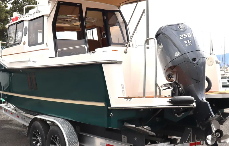 Slide: The Image of 2022 Ranger Tugs R-25 boat with 250 V6 engine on a trailer. - 3