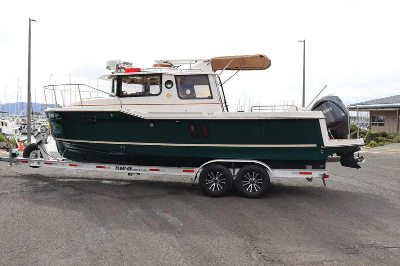 Slide: The Image of 2022 Ranger Tugs R-25 boat on trailer, parked at marina. - 4