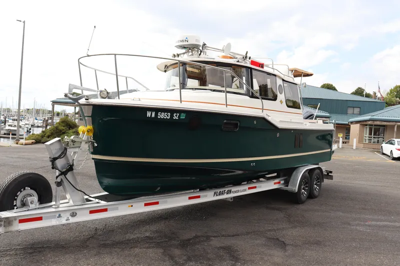 Slide: The Image of 2022 Ranger Tugs R-25 boat on trailer in marina parking lot. - 6