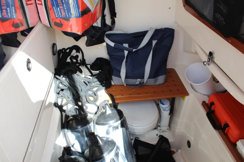 Slide: The Image of Storage area in a 2018 Grady-White Canyon 306 boat with gear and equipment. - 12