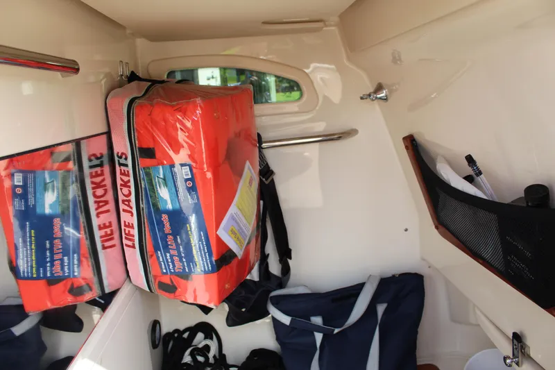 Slide: The Image of Interior of 2018 Grady-White Canyon 306 with life jackets and storage bags. - 13