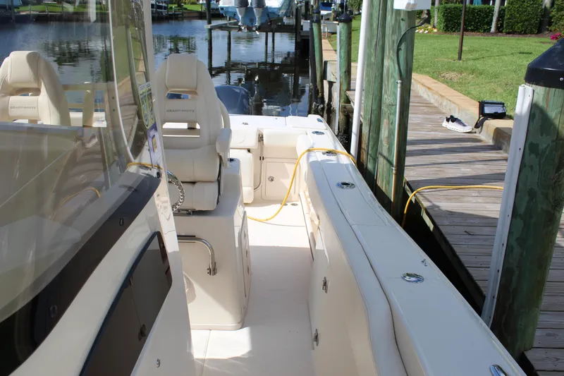 Slide: The Image of 2018 Grady-White Canyon 306 boat docked, featuring spacious seating and sleek design. - 15