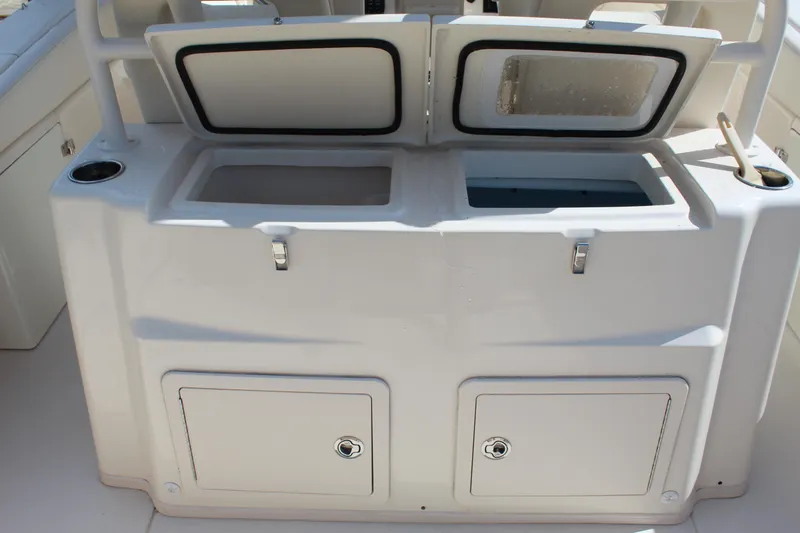 Slide: The Image of 2018 Grady-White Canyon 306 boat storage compartments with open lids and secure latches. - 17