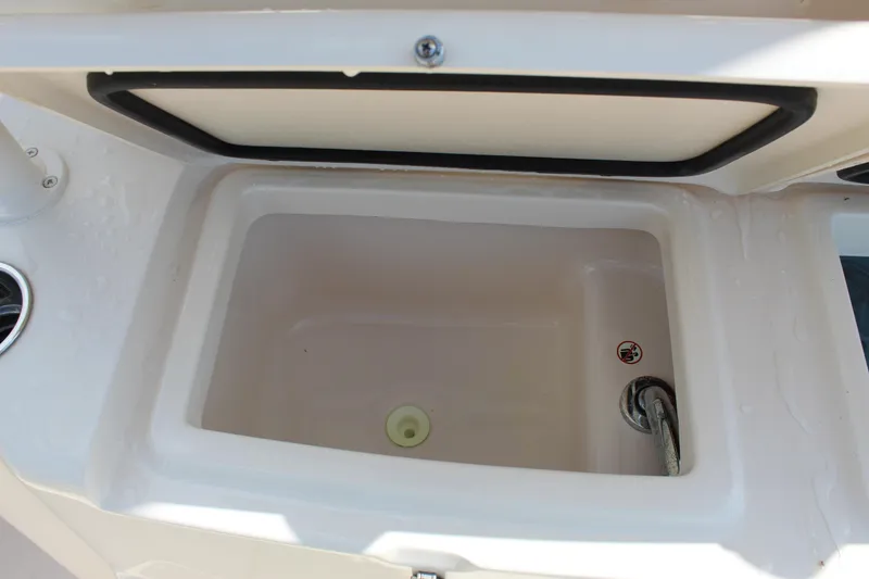 Slide: The Image of 2018 Grady-White Canyon 306 boat storage compartment, open lid, white interior. - 19