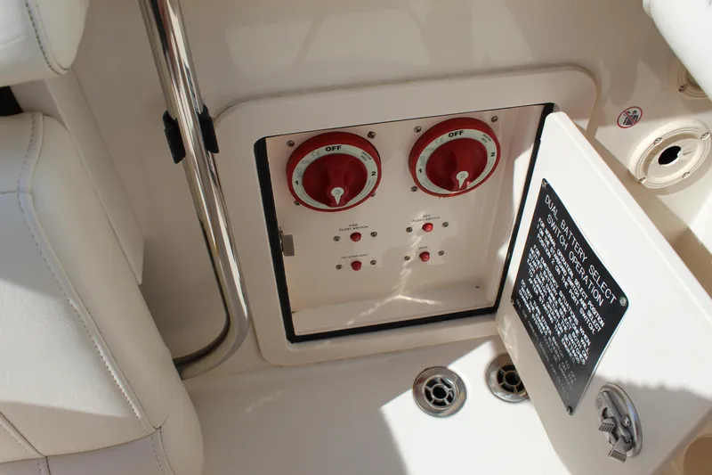 Slide: The Image of Control panel on 2018 Grady-White Canyon 306 boat, featuring switches and dials. - 21