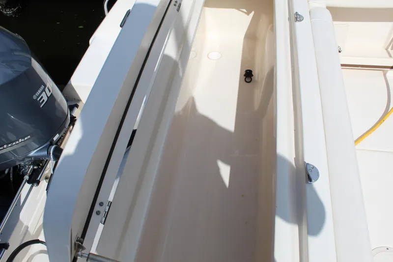 Slide: The Image of 2018 Grady-White Canyon 306 boat storage compartment with open lid. - 22