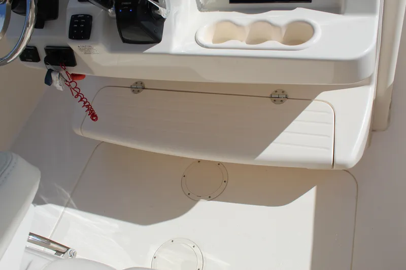 Slide: The Image of 2018 Grady-White Canyon 306 boat interior with control panel and cup holders. - 27