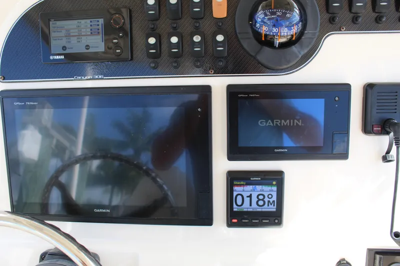 Slide: The Image of Control panel of 2018 Grady-White Canyon 306 with Garmin navigation displays. - 28