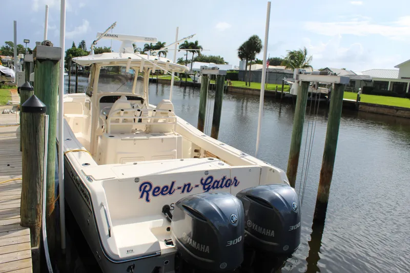 Slide: The Image of 2018 Grady-White Canyon 306 boat docked, featuring dual Yamaha engines. - 6