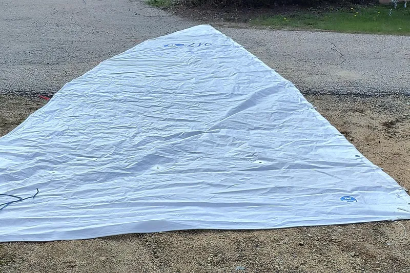 Slide: The Image of White sail for 2008 Hunter 216 boat laid out on ground. - 10