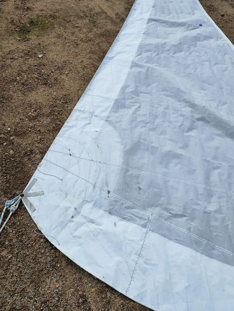 Slide: The Image of Sail from a 2008 Hunter 216 boat laid on the ground. - 11