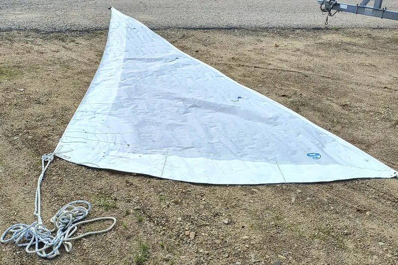 Slide: The Image of Sail for 2008 Hunter 216 boat laid out on ground with attached rope. - 15