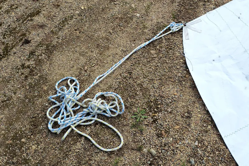 Slide: The Image of Tangled ropes on ground beside a white sail, Hunter 216, 2008 model. - 18