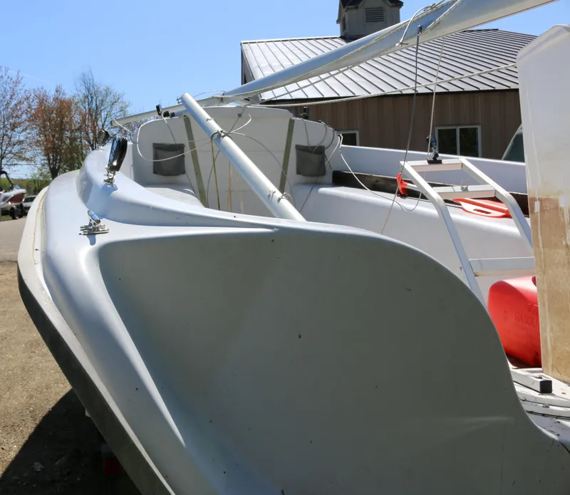 Slide: The Image of 2008 Hunter 216 sailboat on land, with visible mast and deck details. - 3