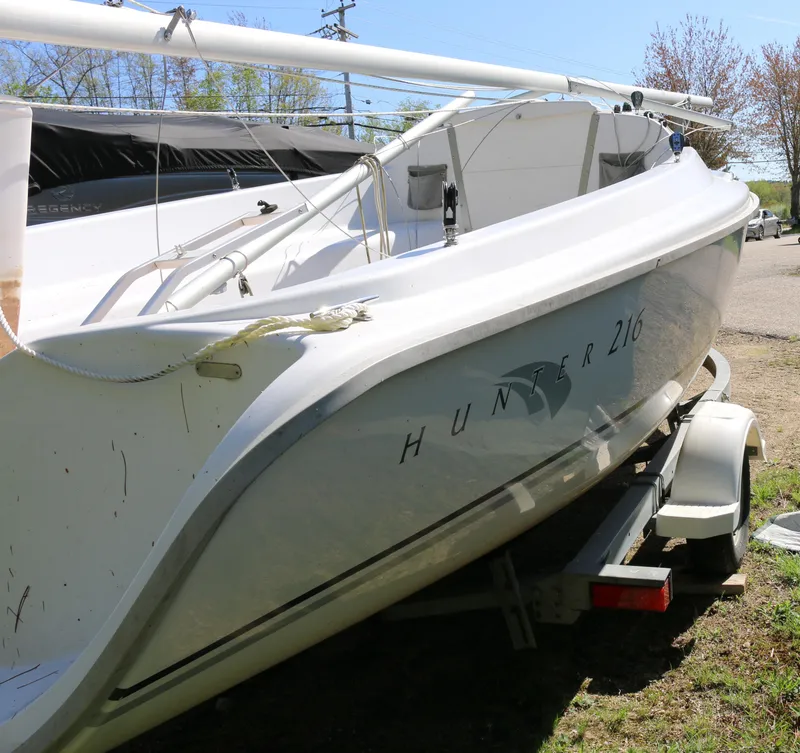 Slide: The Image of 2008 Hunter 216 sailboat on trailer, white hull, outdoor setting. - 4