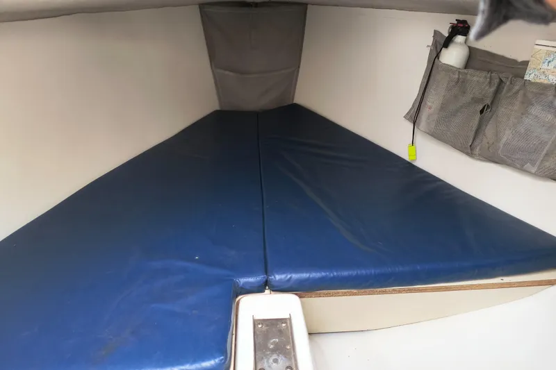 Slide: The Image of Interior cabin of 2008 Hunter 216 sailboat with blue cushions and storage pockets. - 5