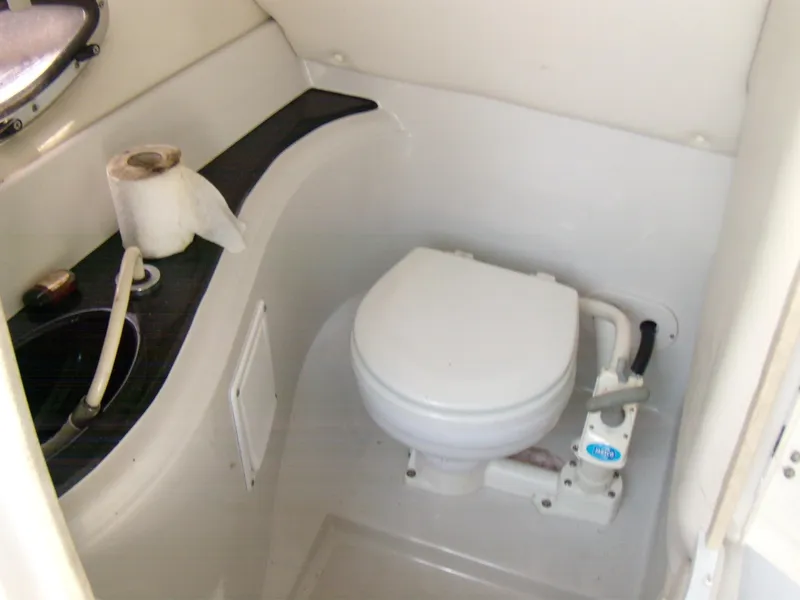 Slide: The Image of 2006 Crownline 260 LS boat bathroom with toilet and sink. - 14