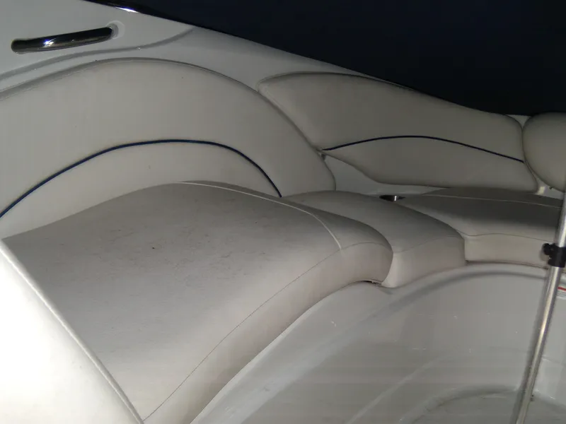 Slide: The Image of 2006 Crownline 260 LS boat interior with white cushioned seating. - 16