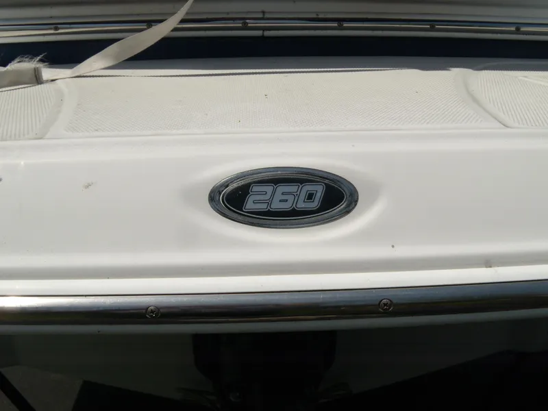Slide: The Image of 2006 Crownline 260 LS boat emblem on white surface. - 3