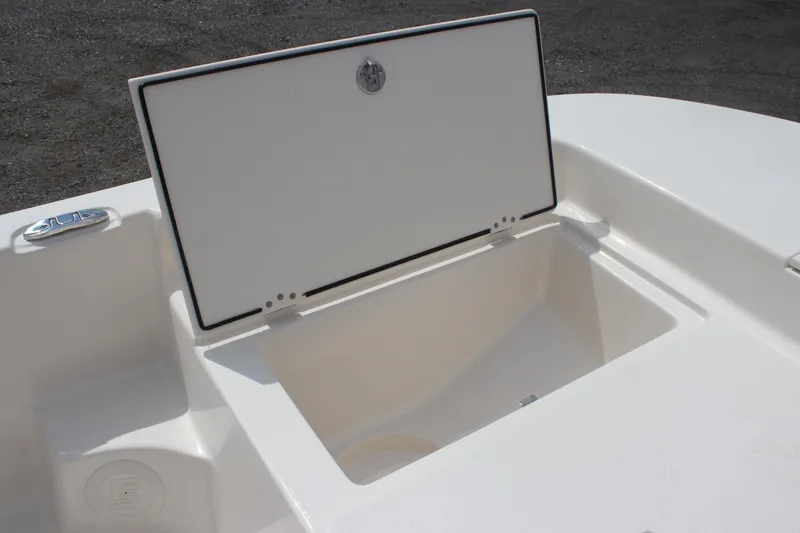 Slide: The Image of 2025 Carolina Skiff 19 LS boat storage compartment open on deck. - 11