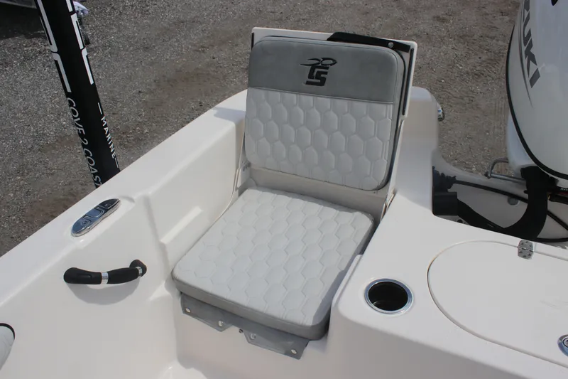 Slide: The Image of 2025 Carolina Skiff 19 LS boat seat with logo, white upholstery, and cup holder. - 12