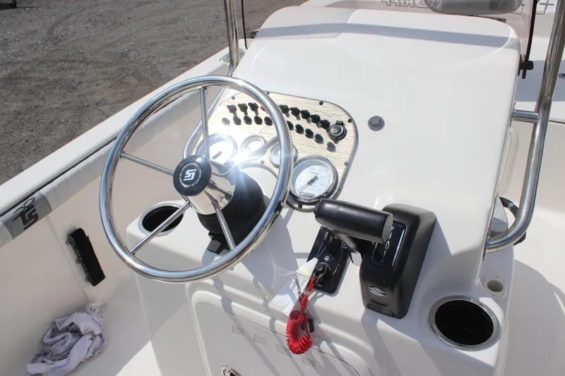 Slide: The Image of 2025 Carolina Skiff 19 LS boat console with steering wheel and controls. - 21