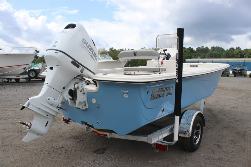 Slide: The Image of 2025 Carolina Skiff 19 LS boat with Suzuki outboard motor on trailer. - 4