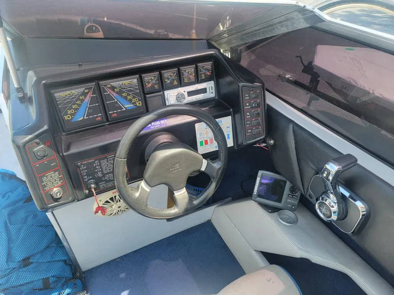 Slide: The Image of 1988 Bayliner 2150 Capri dashboard with steering wheel and control panel. - 12