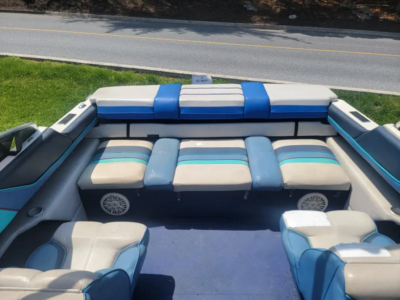 Slide: The Image of 1988 Bayliner 2150 Capri boat interior with blue and beige seating, viewed from above. - 15