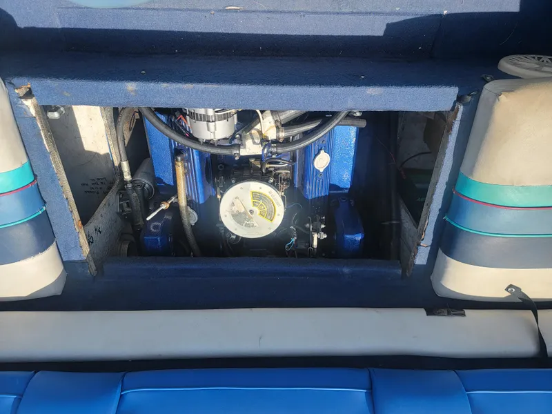 Slide: The Image of 1988 Bayliner 2150 Capri engine compartment with visible blue engine components. - 16