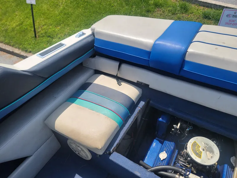Slide: The Image of 1988 Bayliner 2150 Capri boat interior with engine compartment and striped seating. - 17