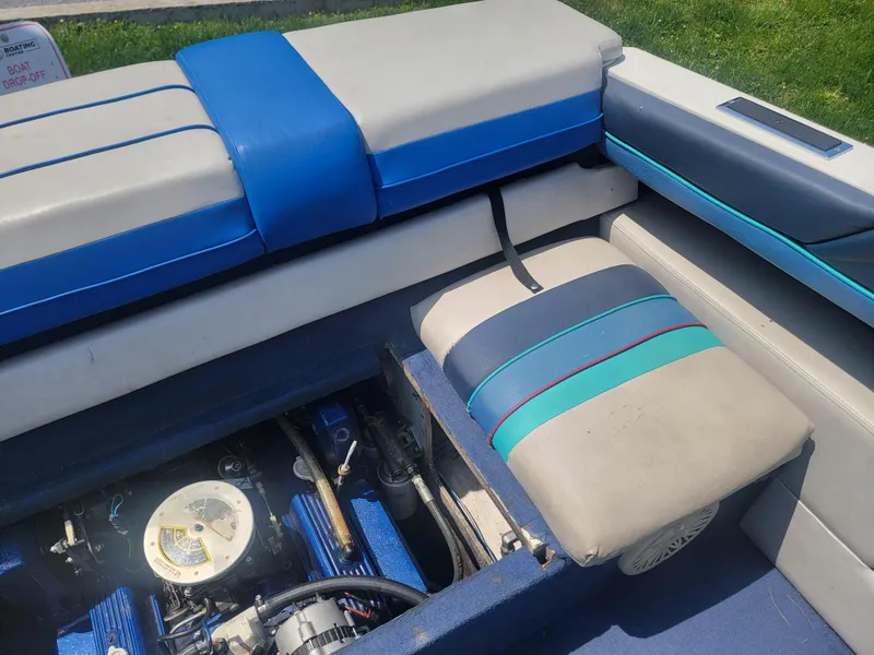 Slide: The Image of 1988 Bayliner 2150 Capri interior with engine compartment and blue seating. - 18