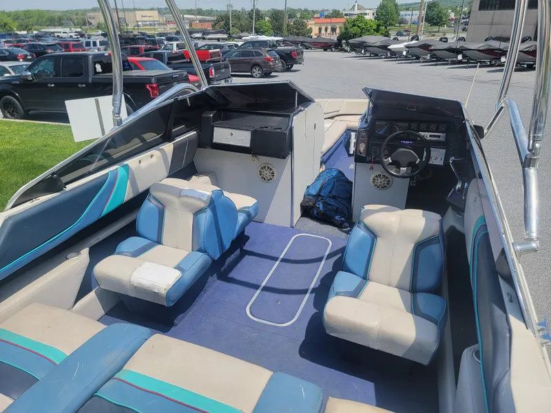 Slide: The Image of 1988 Bayliner 2150 Capri boat interior with blue and white seating, parked outdoors. - 19